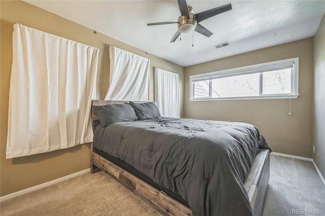 bedroom featuring baseboards, a ceiling fan, carpet, and visible vents