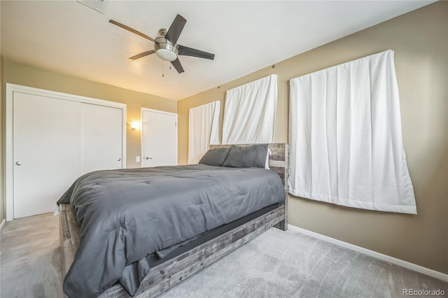 bedroom with ceiling fan, visible vents, baseboards, a closet, and carpet flooring