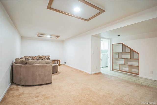 sitting room with washer / dryer, carpet floors, baseboards, and tile patterned floors