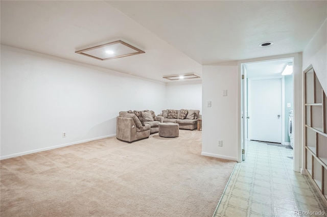 living area with washer / dryer, baseboards, and carpet flooring