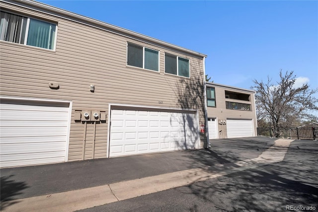 exterior space with a garage, fence, and driveway