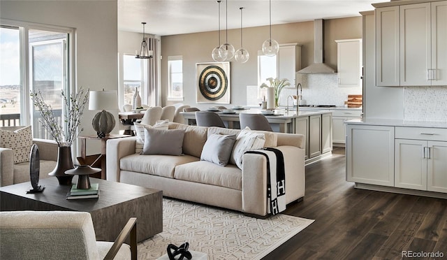 living room featuring a notable chandelier and dark hardwood / wood-style flooring