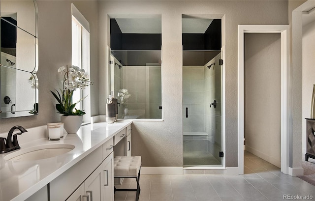 bathroom featuring tile patterned flooring, a shower with door, and vanity