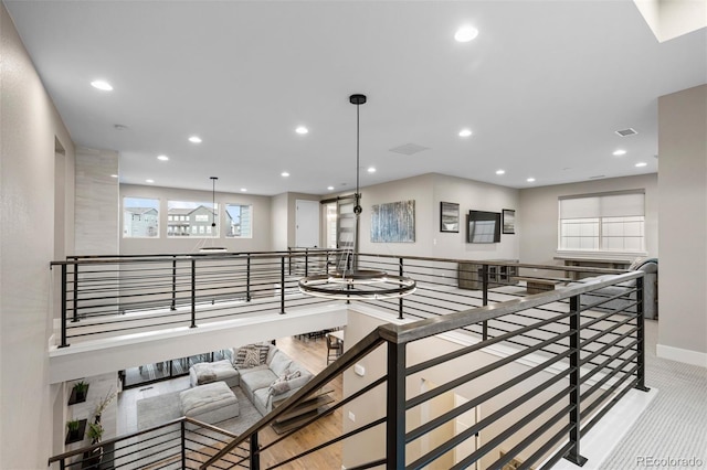 hallway with light colored carpet