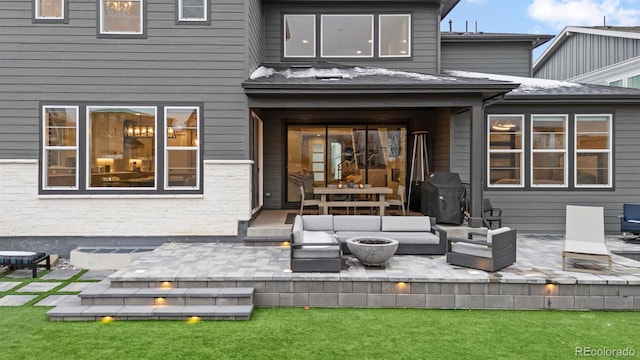 rear view of house with a patio and outdoor lounge area