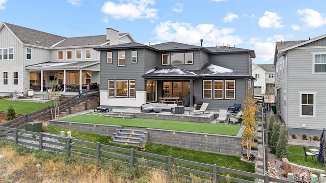 back of house featuring a yard, outdoor lounge area, and a patio