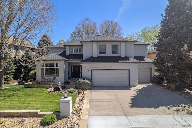 3002 S Oak Way, Lakewood, CO 80227 - traditional-style house with stucco siding, an attached garage, driveway, and a front yard