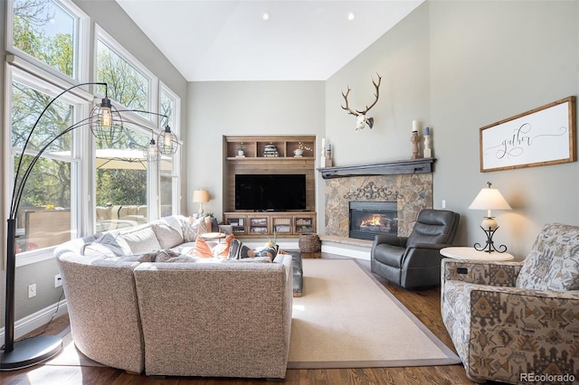 3002 S Oak Way, Lakewood, CO 80227 - living area with wood finished floors, a fireplace, baseboards, and high vaulted ceiling