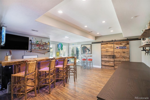 3002 S Oak Way, Lakewood, CO 80227 - indoor dry bar featuring a barn door, wood finished floors, recessed lighting, and baseboards