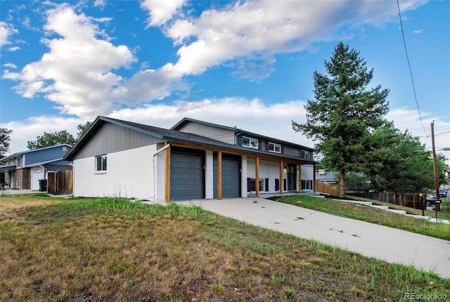 view of front of house with a garage and a front yard