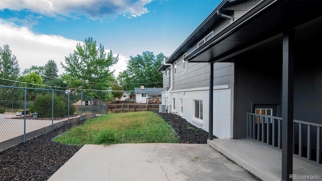 view of yard featuring central air condition unit and a patio