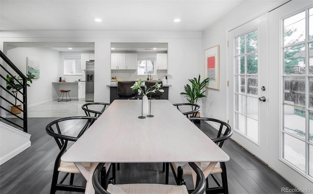 dining room featuring dark hardwood / wood-style floors, sink, and a healthy amount of sunlight