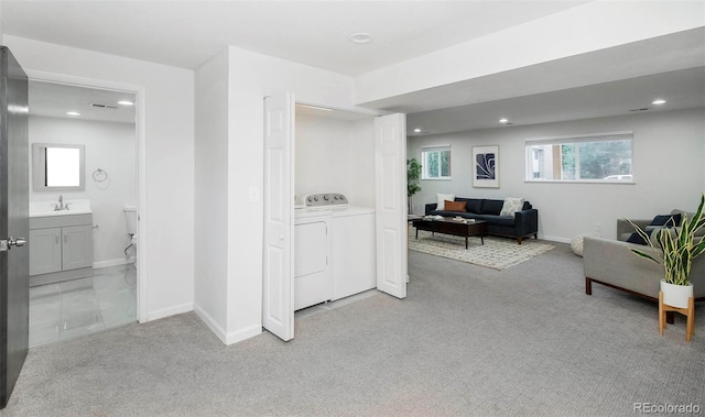 interior space featuring independent washer and dryer and sink