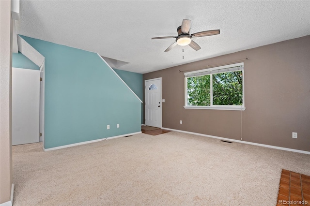 411 S Cody Ct, Lakewood, CO 80226 - unfurnished living room featuring ceiling fan, carpet floors, a textured ceiling, and baseboards