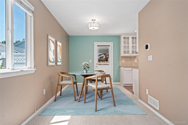 411 S Cody Ct, Lakewood, CO 80226 - dining area with plenty of natural light, light colored carpet, and baseboards