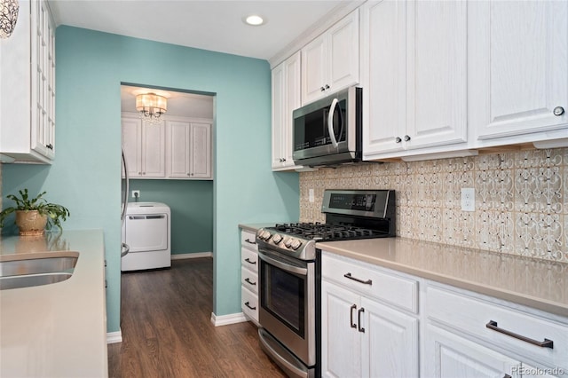 411 S Cody Ct, Lakewood, CO 80226 - kitchen featuring appliances with stainless steel finishes, washer / clothes dryer, white cabinetry, dark wood-style floors, and recessed lighting
