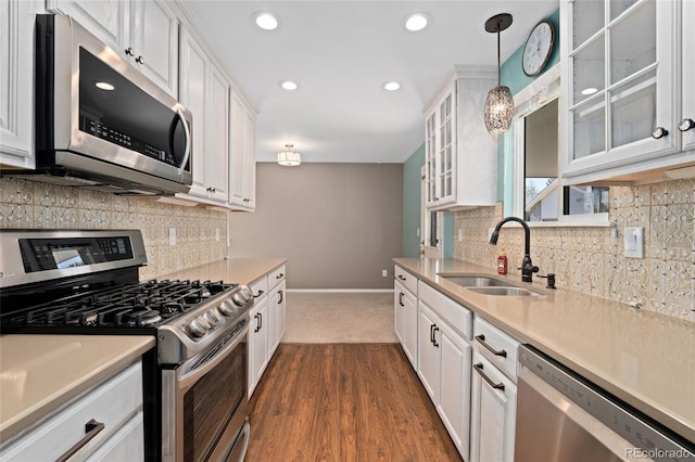 411 S Cody Ct, Lakewood, CO 80226 - kitchen with appliances with stainless steel finishes, a sink, white cabinets, light countertops, and recessed lighting