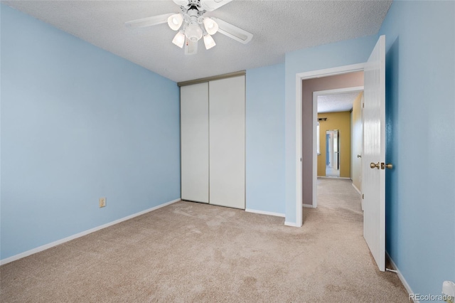 411 S Cody Ct, Lakewood, CO 80226 - unfurnished bedroom with carpet flooring, a textured ceiling, a closet, baseboards, and a ceiling fan