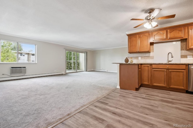 kitchen featuring crown molding, stainless steel dishwasher, sink, light colored carpet, and light stone counters