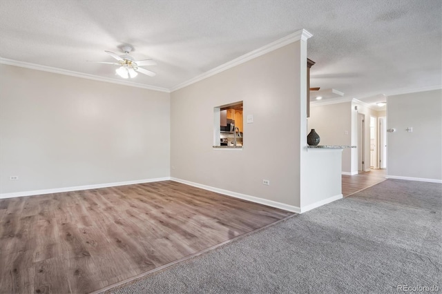 unfurnished room featuring dark wood-type flooring, a textured ceiling, ceiling fan, and ornamental molding