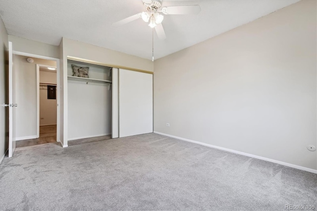 unfurnished bedroom with ceiling fan, carpet, and a closet