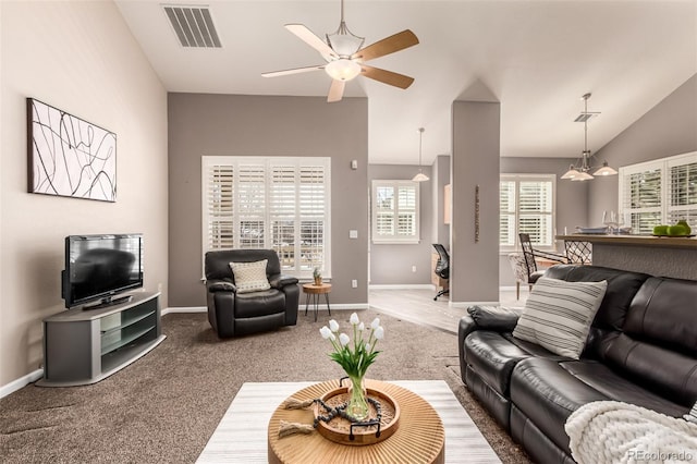 carpeted living area featuring lofted ceiling, baseboards, visible vents, and a ceiling fan