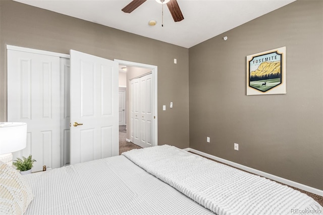 bedroom featuring a ceiling fan, dark carpet, and baseboards