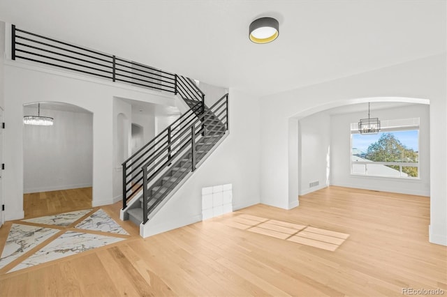 foyer entrance with a chandelier and hardwood / wood-style floors