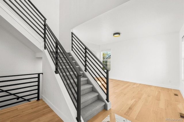 staircase with wood-type flooring