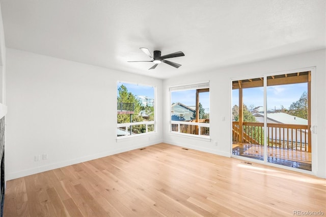 spare room with ceiling fan and light wood-type flooring