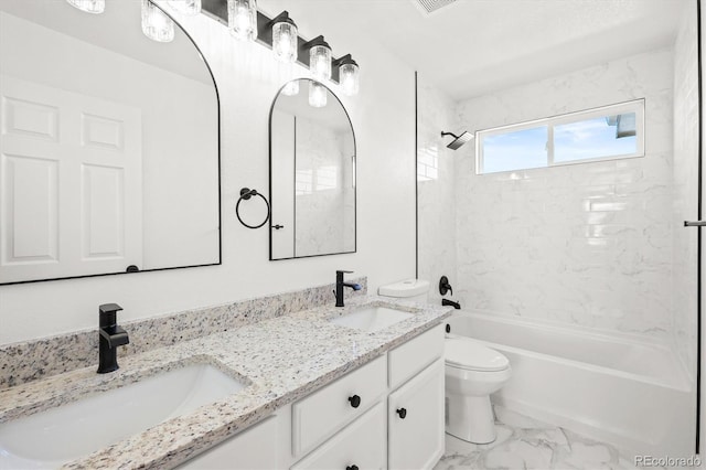 full bathroom featuring vanity, toilet, and tiled shower / bath