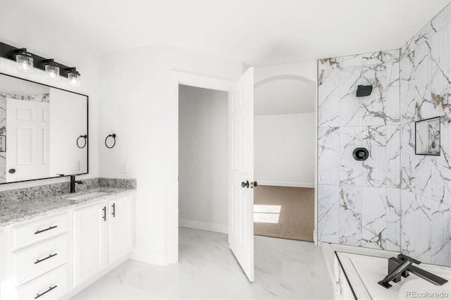 bathroom featuring vanity and tiled shower