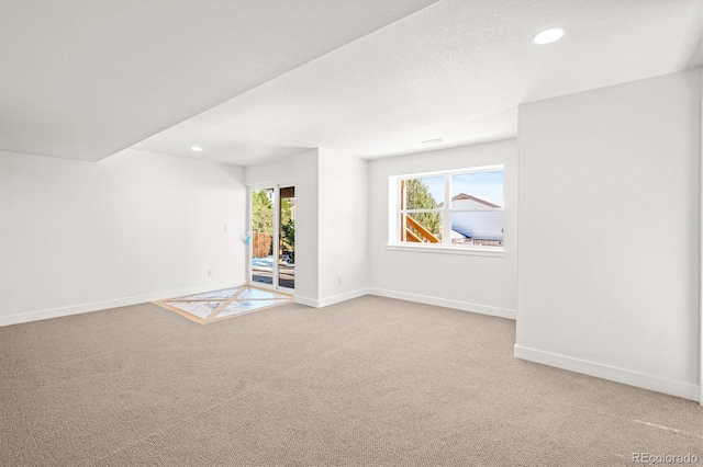 unfurnished room featuring light carpet