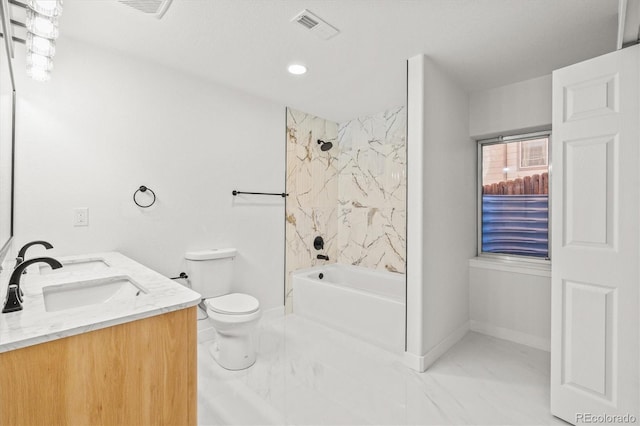 full bathroom with toilet, vanity, and tiled shower / bath