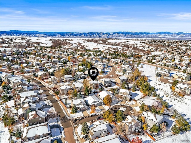 snowy aerial view featuring a mountain view