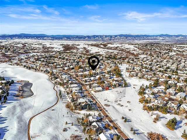 snowy aerial view featuring a mountain view