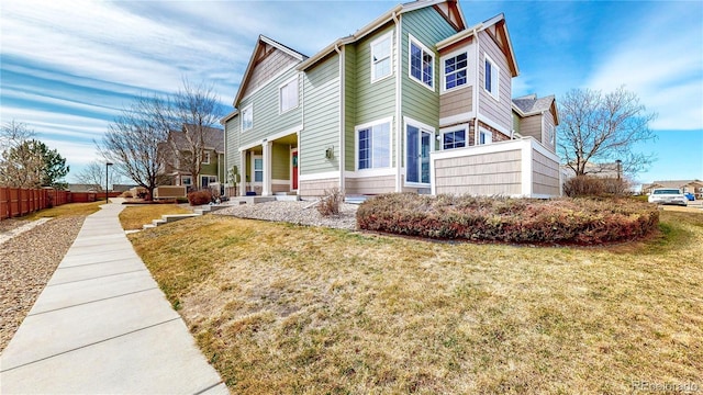 view of side of property with a yard and fence