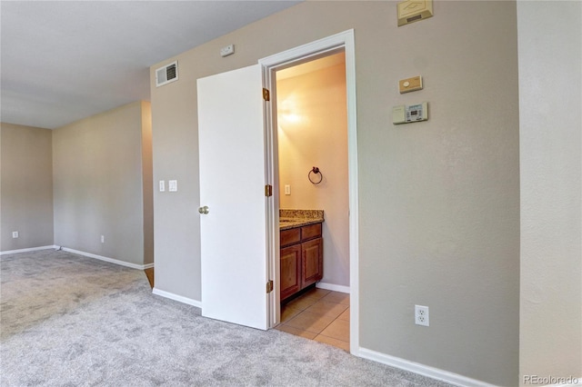 carpeted bedroom featuring ensuite bathroom