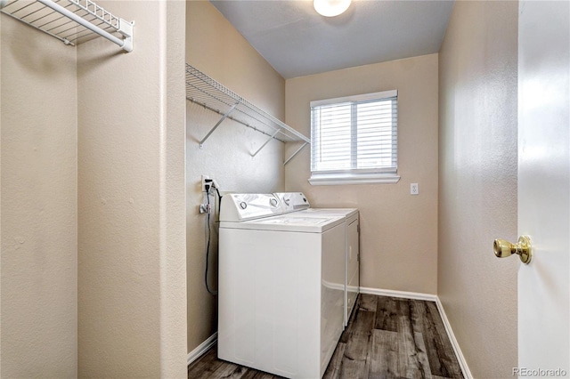 laundry area with dark hardwood / wood-style flooring and washing machine and dryer