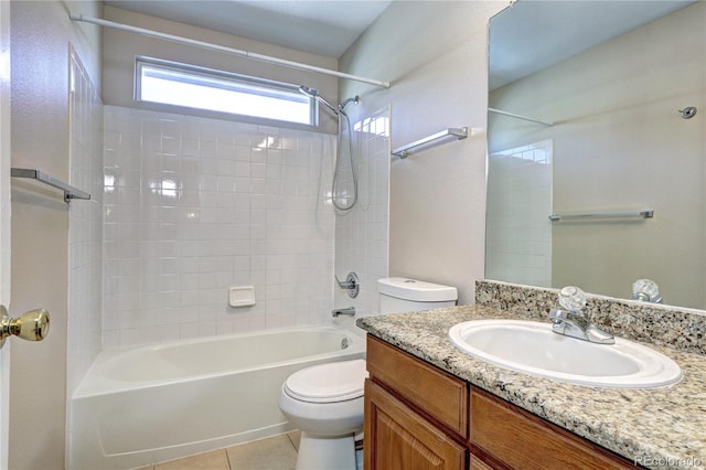 full bathroom with tiled shower / bath, vanity, toilet, and tile patterned floors