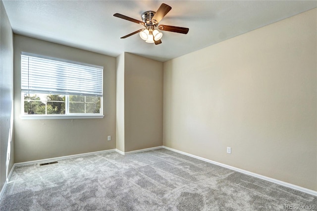 empty room with ceiling fan and light colored carpet