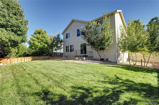 back of house featuring a yard