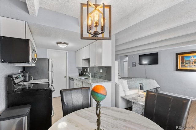 dining room with a textured ceiling and washer / dryer