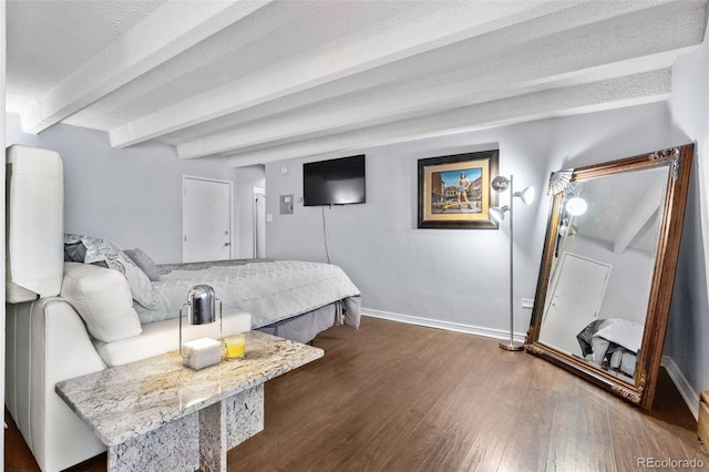 bedroom featuring beamed ceiling, dark wood-type flooring, and baseboards