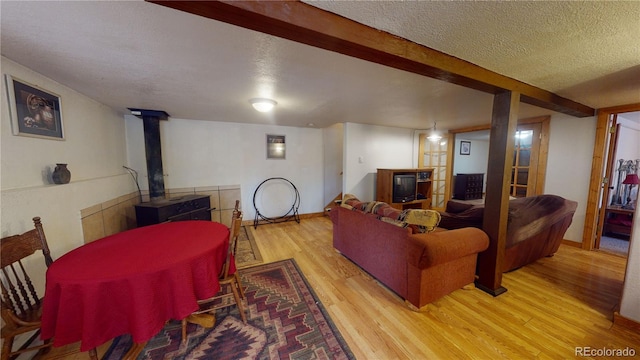 living room with a textured ceiling and light hardwood / wood-style flooring