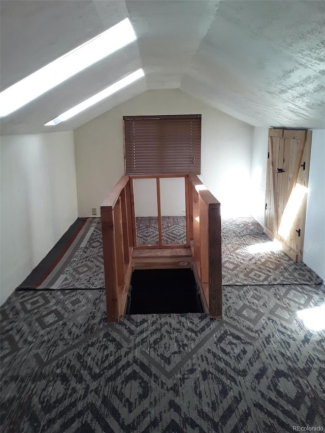 bonus room with carpet flooring and lofted ceiling