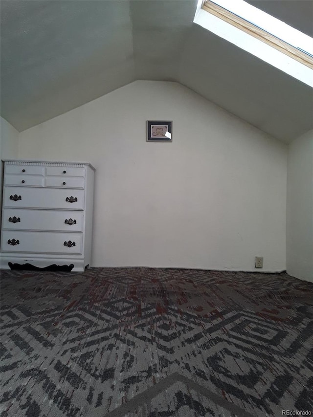 bonus room featuring lofted ceiling with skylight and carpet