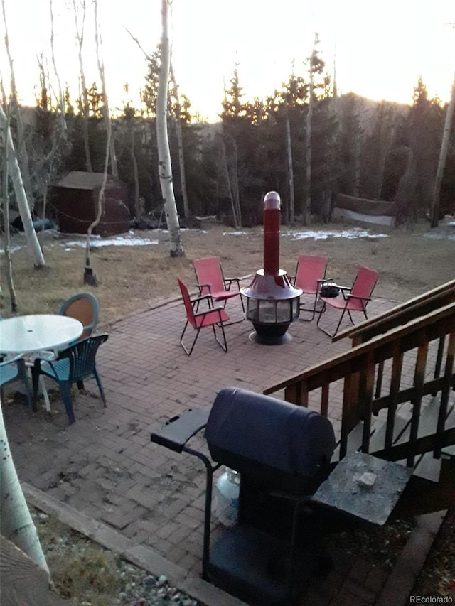 patio terrace at dusk with an outdoor fire pit