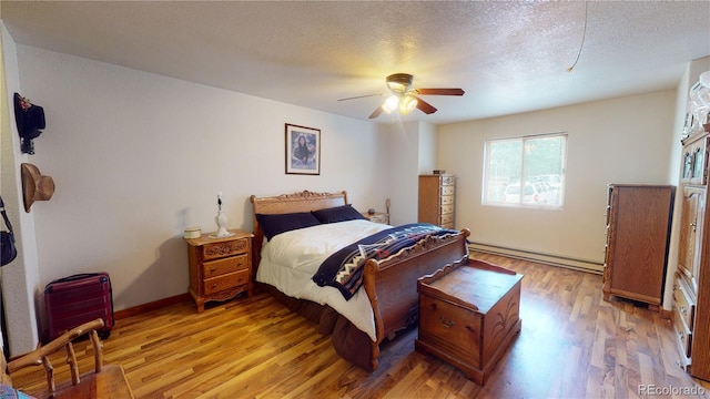 bedroom featuring a baseboard radiator, light hardwood / wood-style flooring, a textured ceiling, and ceiling fan