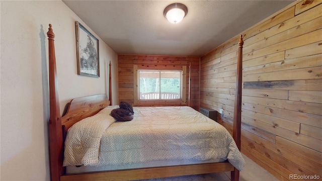 bedroom featuring wooden walls